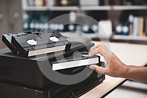 Close-up hand putt playback button on video record player concept of retro style or vintage electric and electronic appliances