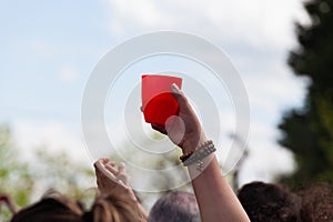 Close-up hand with red plastic cup