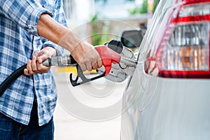 Close-up hand of refuel the car by yourself, Pumping equipment gas at gas station