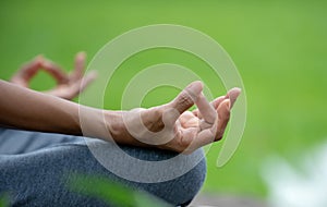Close up hand senior woman yoga and lotus pose meditation and relax in the nature park