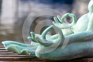 Close up hand. Stone frog doing yoga outdoor. Zen relax and relaxation yoga at the nature background