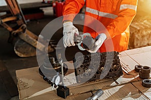 Close up hand of technician holding piston of the hydraulic pump to inspection and repair maintenance heavy machinery, Industrial