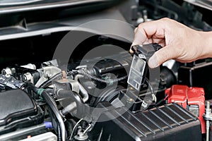 Hand a Technician remove airflow sensor in the engine room car for check and cleaning in service concept photo