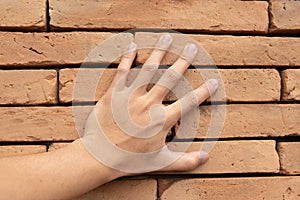 Close up Hand touched on the brick wall surface