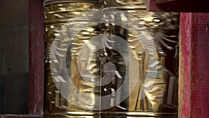 Close up hand touching the prayer wheels near the Gandan Monastery in Ulaan Bataar, Mongolia