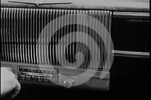 Close-up of hand tuning radio in vintage car