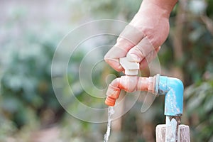 Close up hand is turning off faucet. Concept, Save water for environment.