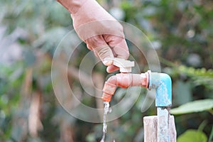 Close up hand is turning off faucet. Concept, Save water for environment.