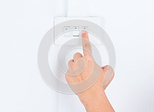Close up hand turning on or off on light switch