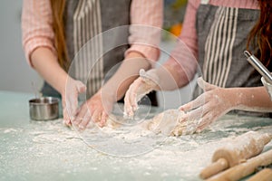 Close up hand of two woman thresh flour for cooking with other tools or accessories in the kitchen look like family activities