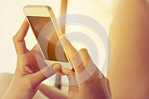 Close up of hand typing on phone