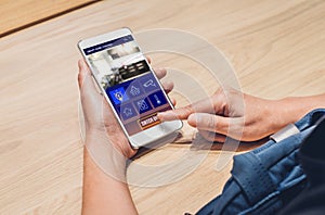 Close up hand use smart home control app on mobile phone switch