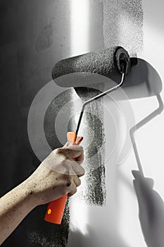 Close up of hand using paint roller