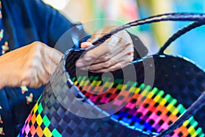 Close up hand of weaver during weaving basket made from plastic