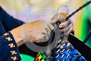 Close up hand of weaver during weaving basket made from plastic