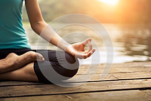 Close up hand. Woman do yoda outdoor. Woman exercising yoga at the nature background.