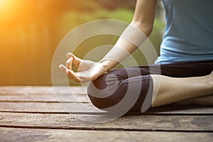 Close up hand. Woman do yoda outdoor. Woman exercising yoga at the nature background