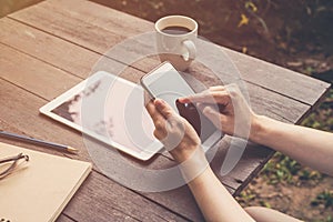 Close up hand woman holding phone in coffee shop