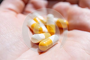 Close up hand of woman overdosing on medication.