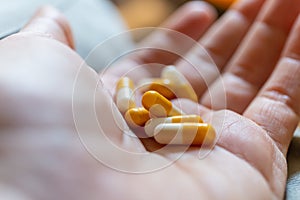 Close up hand of woman overdosing on medication.