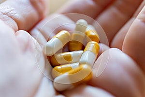 Close up hand of woman overdosing on medication.