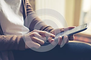 Close up of hand woman typing on smart phone