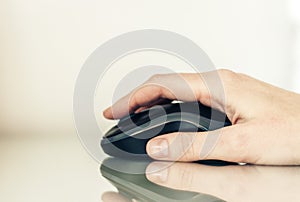 Close-up of hand woman using a computer mouse on glass table, business concept