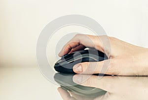 Close-up of hand woman using a computer mouse on glass table, business concept