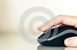 Close-up of hand woman using a computer mouse on glass table, business concept