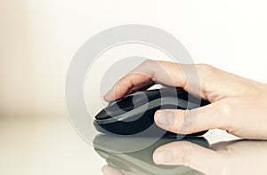 Close-up of hand woman using a computer mouse on glass table, business concept