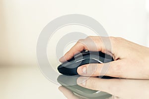 Close-up of hand woman using a computer mouse on glass table, business concept