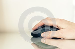 Close-up of hand woman using a computer mouse on glass table, business concept