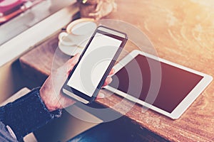 Close up hand woman using phone in coffee shop