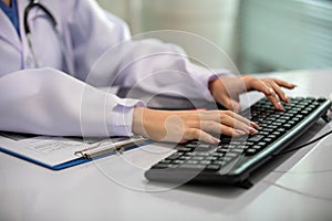 Close-up hand women doctor typing on keyborad for working