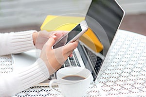 Close up hand women play smart phone for sale online. Work space relaxing chill out work for office and design laptop