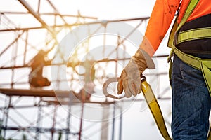 Close up hand of Worker in construction site Working at height equipment. Fall arrestor device for worker with hooks for safety