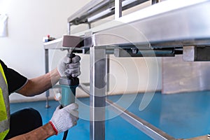 Close up of hand Worker use Electric wheel grinding on Polishing of varnish after painting the Aluminum on product sorting machine