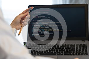 Close-up of hand working on laptop. woman working on coding on laptop