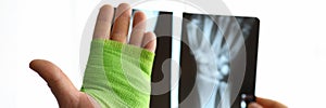 Close-up hand wrapped in bandage and x-ray hand
