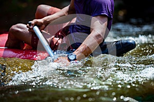 Close-up hand of young men is rafting on the river