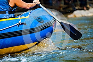 Close-up hand of young person is rafting on the river