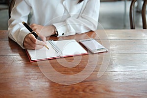 Close up. hand of young student woman holding pen for writing on