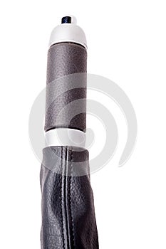 Close-up of a handbrake handle covered in black leather with chrome elements on a white isolated background in a photo studio for