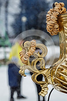 Close-up handle. Large metal gold old traditional Russian samovar for tea drinking.