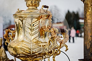 Close-up handle. Large metal gold old traditional Russian samovar for tea drinking.