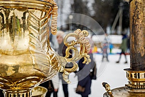 Close-up handle. Large metal gold old traditional Russian samovar for tea drinking.