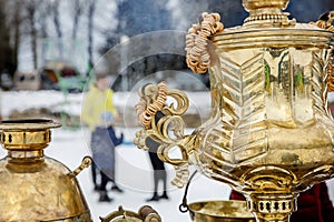 Close-up handle. Large metal gold old traditional Russian samovar for tea drinking.