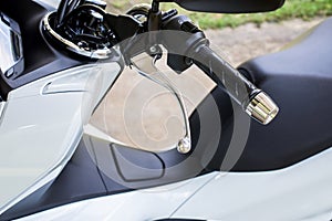 Close up of handlebars and front break on motorcycle