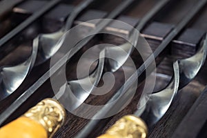 Close up handles Big luxury stainless steel skewers set in wooden box for grill and barbecue. Expensive high quality exclusive