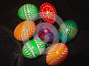 Close up of handmade colorful eastereggs on a black table